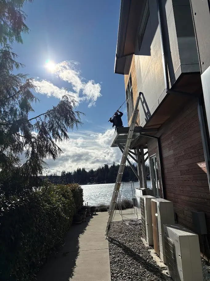 Window cleaner performing residential window cleaning in Gig Harbor, WA for Father & Son Window Cleaning