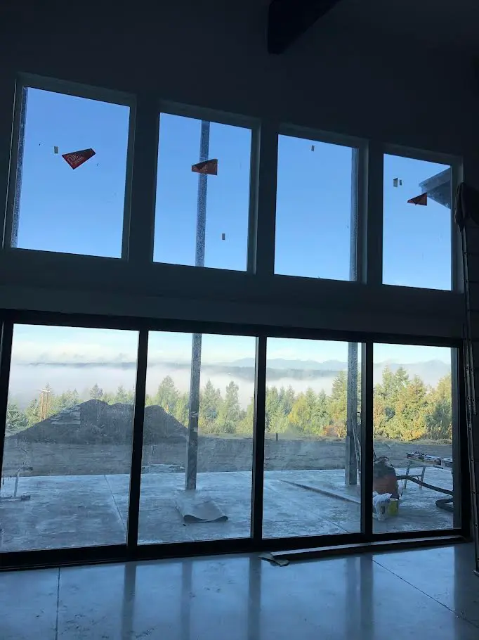 Waterfront property roof cleaning in progress in Gig Harbor, WA by Father & Son Window Cleaning